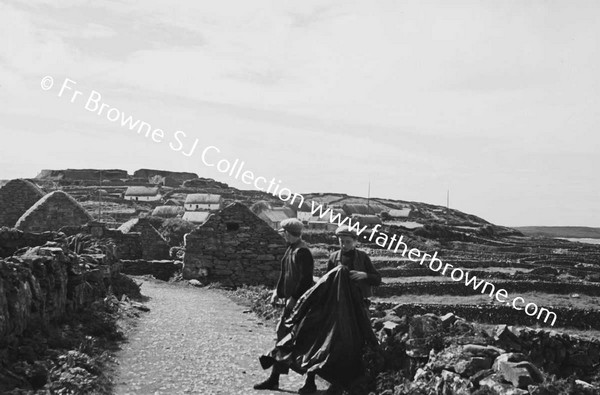 MEN ON ROAD NEAR VILLAGE